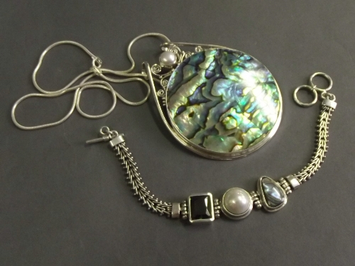 A large silver and abalone and pearl set pendant (2½'' diameter) on silver necklace, and a silver