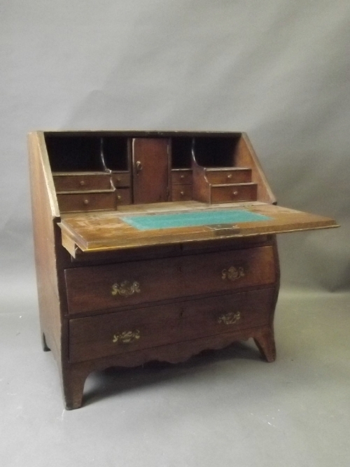 A late C18th/early C19th bombe shaped fall front bureau of small proportions, with fitted stepped