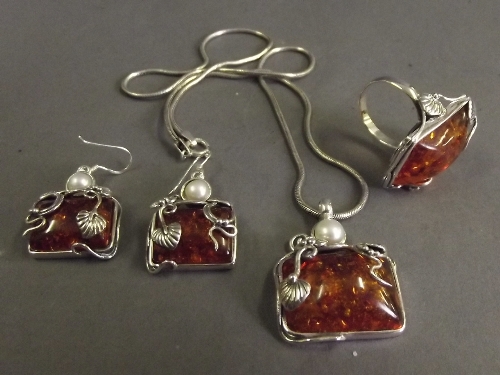 A silver necklace with amber and pearl style silver set pendant, a matching pair of earrings and