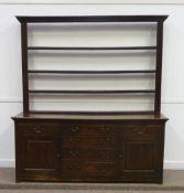 George III oak dresser fitted with six drawers and two cupboards, fielded panelled sides, panelled