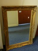 Rectangular wall mirror in swept gilt frame