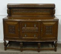 Early 20th Century oak sideboard, shaped front, pineapple finials, carved with berries, W154cm