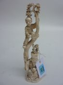 Japanese carved ivory okimono of two figures in a tree, 24cm high