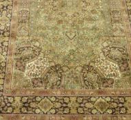 Persian design green ground rug, 230cm x 147cm