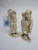 Pair of Japanese carved ivory okimono of a man and woman 15cm high