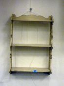 Painted pine three level wall shelf with pierced ends