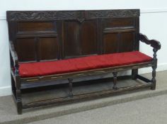 Early 18th Century oak settle, panelled back dated 1702 monogrammed IBM, string seat, W183cm