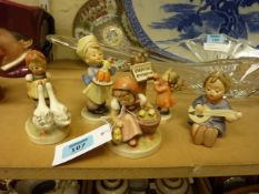 Four Goebel girl figurines and one angel