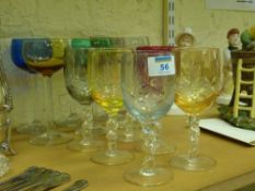 Set of six coloured harlequin wine glasses and hand cut wine glasses and a pair of binoculars