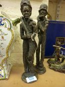 Pair of stoneware African figure signed Good Harvester and Mealie Eater