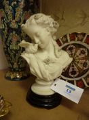 Victorian parian bust of a girl with a dove
