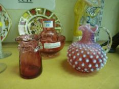 Victorian cranberry jug with milky translucent highlights and three other pieces of cranberry glass