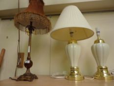 Three table lamps and a narrow rectangular bevelled edge wall mirror
