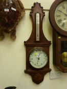 Edwardian aneroid barometer retailed by Odgen of Harrogate, carved oak surround