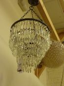 Early 20th Century centre light fitting of four tiers of cut crystal drop