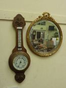 Edwardian oak cased aneroid barometer with thermometer and a circular bevelled edge mirror in gilt