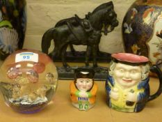 Glass paperweight, two pottery character jugs and a pair of cast iron door stops