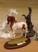 Three bisque sculptures of horses