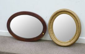 Gilt framed oval wall mirror and a mahogany framed oval wall mirror