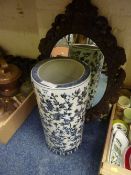 Oriental blue and white umbrella stand and an oval wall mirror
