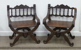 A pair of late 19th Century Italian design carved oak 'X' shaped elbow chairs