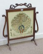 Late Victorian mahogany fire screen with embroidered Peacock panel