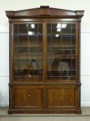 Irish Regency mahogany library bookcase on cupboard, two astragal glazed doors with fluted half