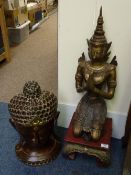 Brass kneeling Buddha on painted stand 87cm overall and a carved Buddha's face mask