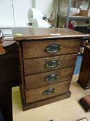 Miniature oak chest of four drawers