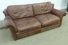 Three seat settee in distressed brown leather