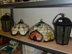 Pair of cast iron hanging lanterns and two leaded glass centre light fittings