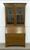Edwardian oak bureau bookcase, two lead glazed doors above fall front and three drawers, 107cm wide