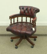 Swivel / reclining tub shaped captain's desk chair in deeply buttoned burgundy leather