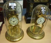 Early 20th Century brass 400 day clock under glass dome and a similar clock missing its pendulum