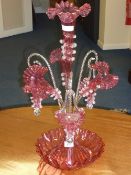 Cranberry glass epergne centrepiece with four flutes and three pendant baskets 62cm