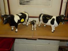 Beswick Fresian Bull and a CH. Coddington Hilt Cow and Calf