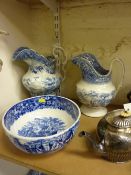 Two early 19th Century blue and white print ware toilet jugs and a late Victorian Wedgwood blue