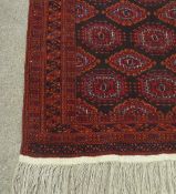 Persian handmade Bokhara pattern red ground rug, 200 x 125cm