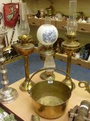 Four brass oil lamps and a Victorian brass preserve pan