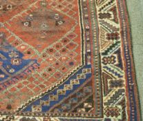 Persian 'Shiraz' hand made red ground rug, 215cm x 143cm
