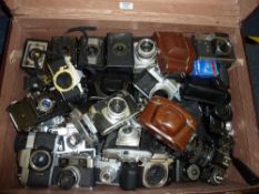 Large selection of cameras, lenses and photographic equipment in a travelling trunk