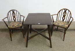 Ercol dark elm drop leaf table and two matching carver chairs