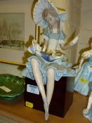 Lladro figure of a girl with a doll on wooden plinth
