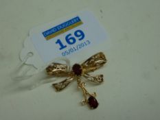 Gold bow brooch set with garnets hallmarked 9ct