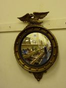 Regency style convex mirror with eagle pediment