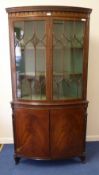 Quality Edwardian mahogany bow front double corner cabinet, astragal glazed doors above two