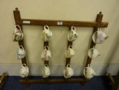 Collection of 12 moustache cups and display rack