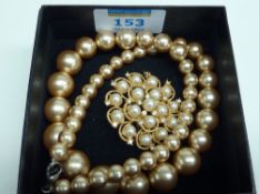 Pearl diamante brooch and a gold-shell pearl necklace