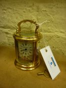 Small circular brass carriage clock with enamel dial and panels 10.5cm