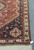 Persian Shiraz black ground hand made rug, 243cm x 165cm